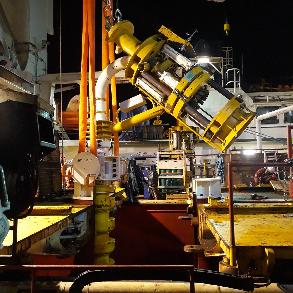 Subsea equipment on a vessel deck at night